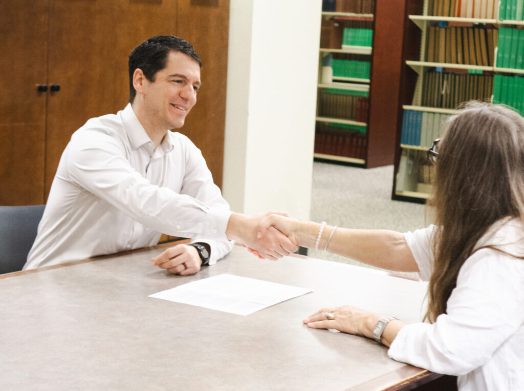 Adam Rodrigues Post Conviction Lawyer shaking hands with client